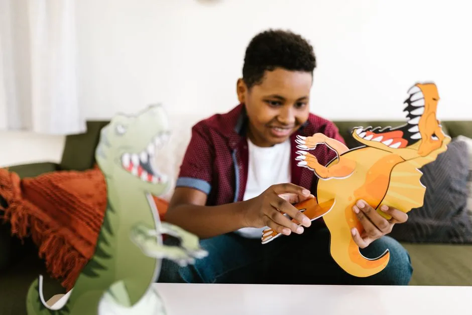A child creating paper dinosaur crafts indoors, enjoying creative play and learning.