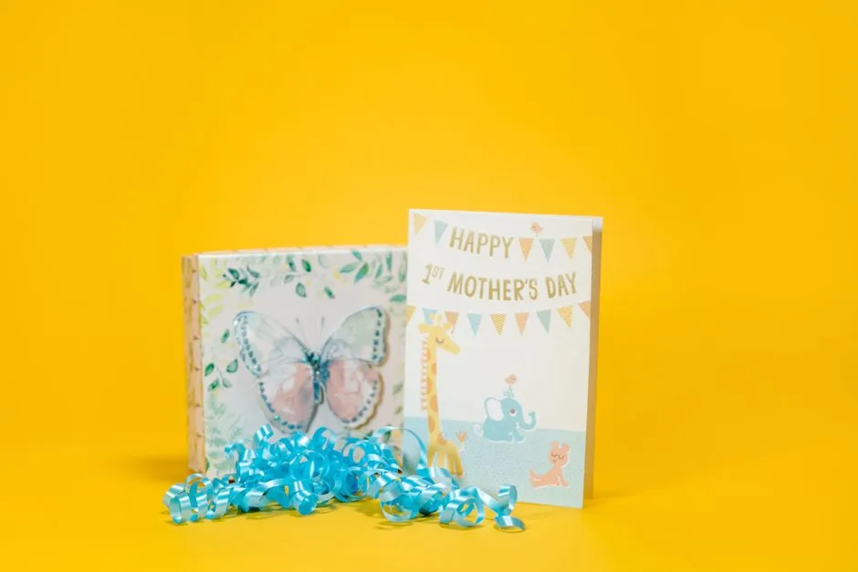 Vibrant Mother's Day card and gift box with butterfly design on bright yellow background.