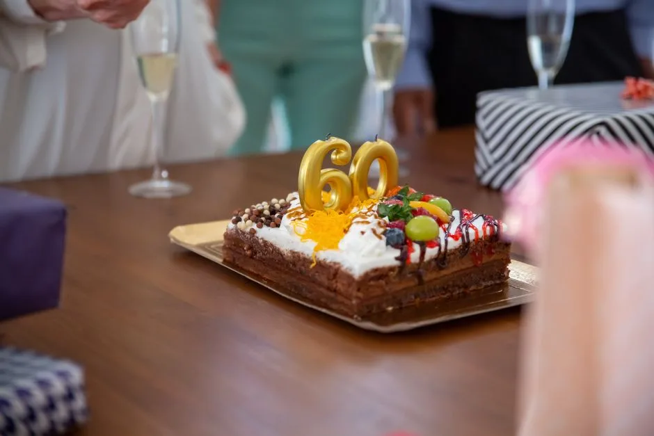 A delicious chocolate cake with 60 candles, perfect for a milestone birthday celebration.