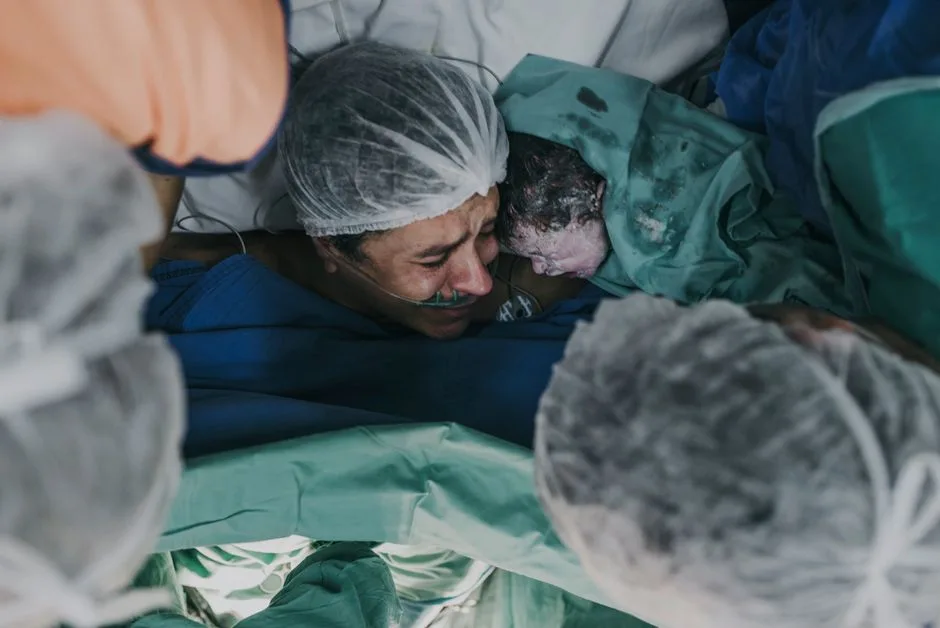 A powerful capture of a mother and her newborn in a hospital setting, showcasing raw emotion and the miracle of birth.