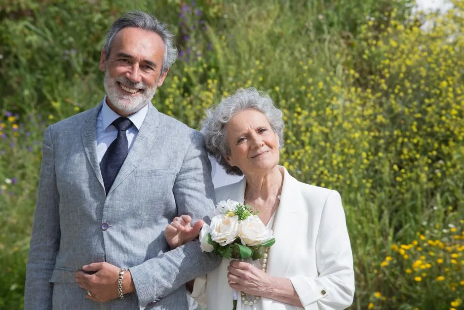 Smiling elderly couple in formal wear enjoying a beautiful day outdoors in Portugal.