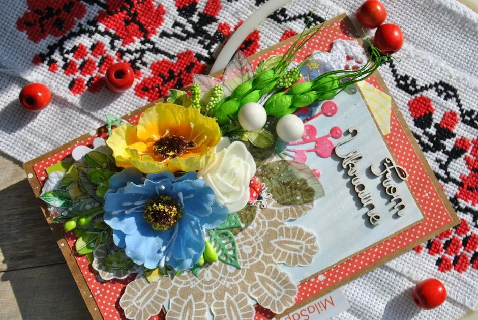 Colorful handmade card with vibrant flowers on traditional Ukrainian fabric.
