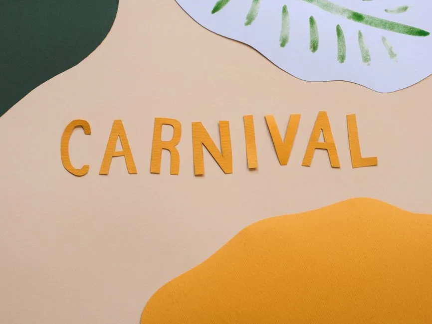 A vibrant carnival-themed decoration with cut-out paper letters on a pastel background.