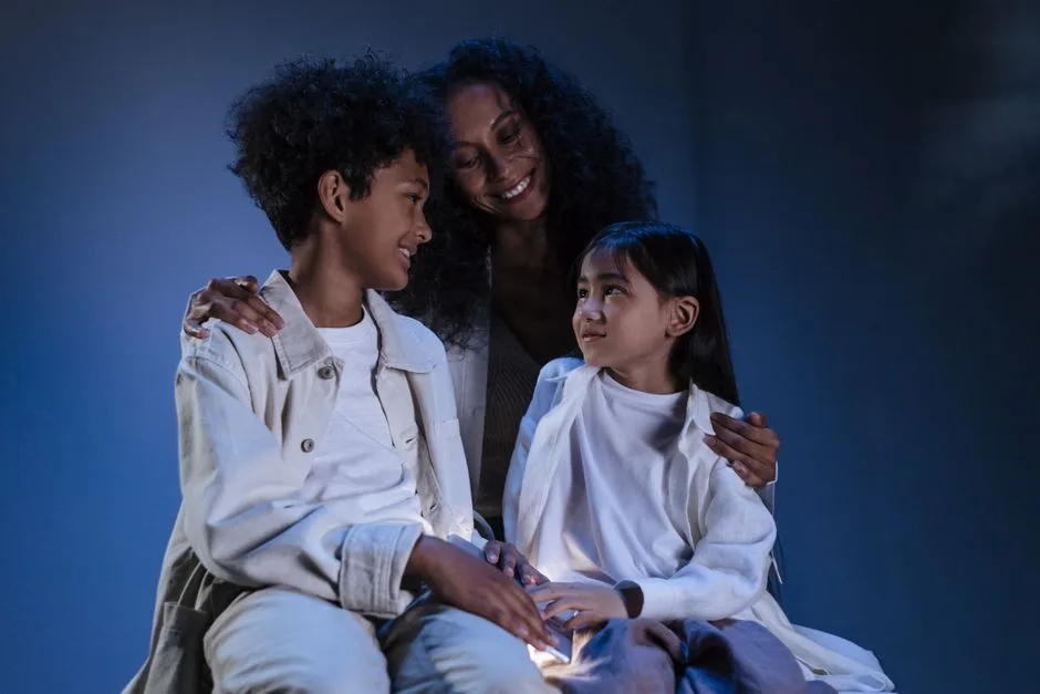 A warm scene of a mother embracing her two children with love and care.
