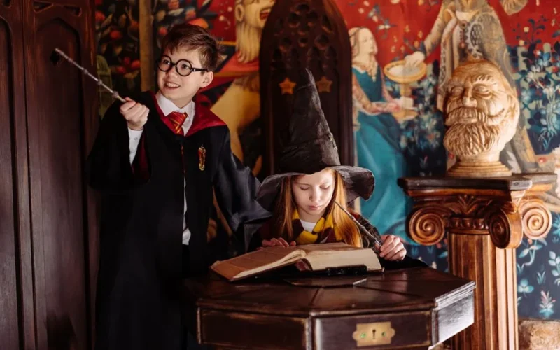 Children dressed as wizards engaged in magic-themed play, exploring spells in a fantasy setting.