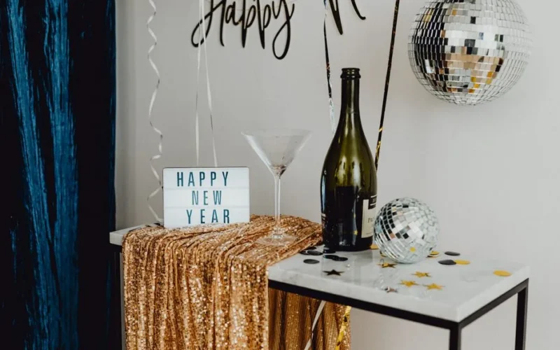 A festive New Year's Eve setup featuring champagne, disco balls, and celebratory decor.