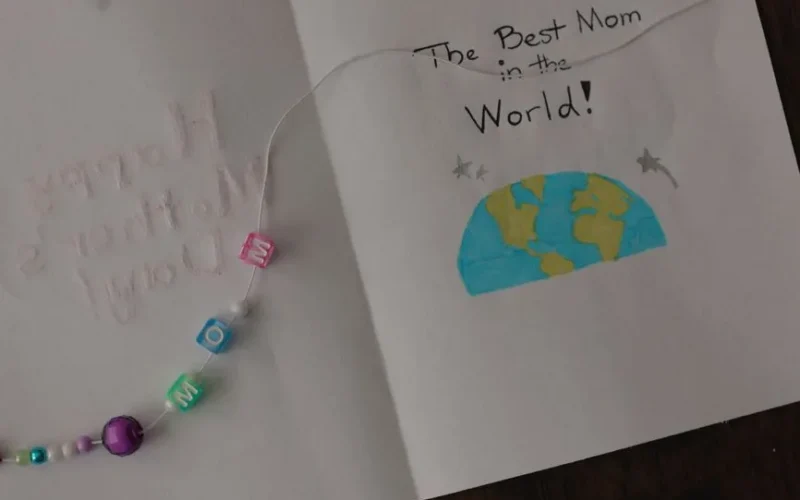 Handmade Mother's Day card featuring beaded bracelet and heartfelt message.