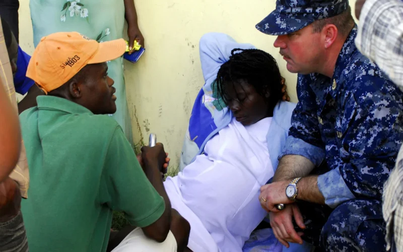 BONEL, Haiti (Jan. 27, 2010) Senior chief hospital corpsman Bryant, from the amphibious dock landing ship USS Fort McHenry (LSD 43), discusses treatment of a pregnant Haitian woman during an emergency response in Bonel, Haiti. The multi-purpose amphibious assault ship USS Bataan (LHD 5) is on station in Haiti along with the amphibious dock landing ships USS Fort McHenry (LSD 43), USS Gunston Hall (LSD 44), and USS Carter Hall (LSD 50) as the Bataan amphibious relief mission supporting operation Unified Response, a joint operation providing military support capabilities to civil authorities to help stabilize and improve the situation in Haiti following a 7.0 magnitude earthquake that devastated the island nation on Jan. 12, 2010.
