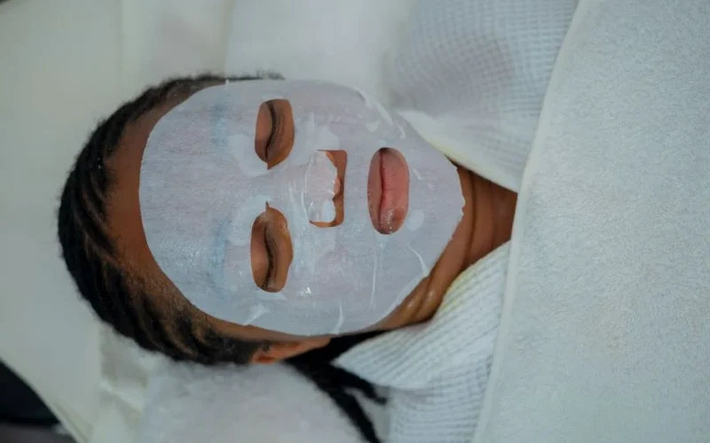 Woman enjoying a rejuvenating facial mask treatment at a spa in Abuja, Nigeria.