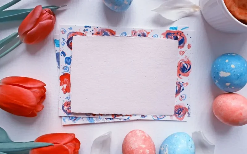 Colorful Easter-themed flat lay with tulips and painted eggs for festive decoration.