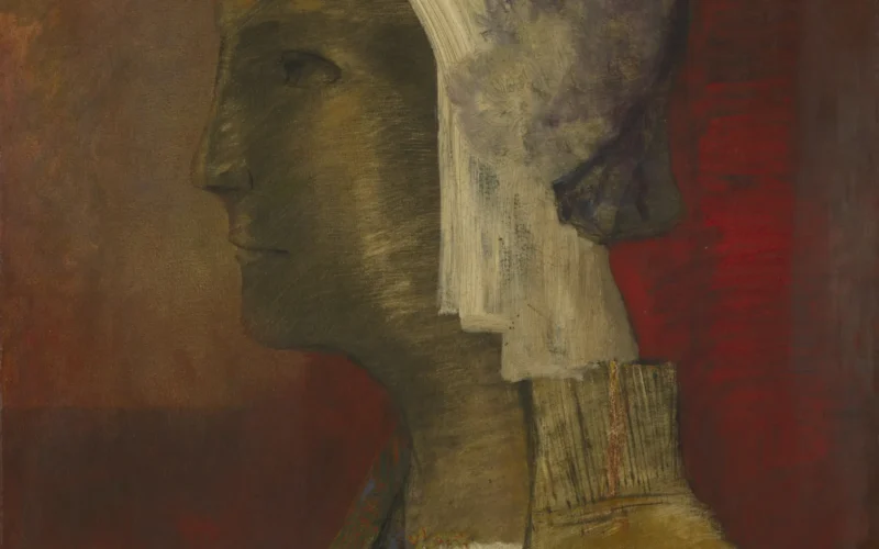 One of Redon's favorite themes of the 1880s and 1890s was a human head depicted in profile. This motif came from his representations of severed heads, often carried aloft on wings, published in the artist's first album of prints, Dans le rêve (1879). In these images, the separation of the head from the body symbolizes the spirit released from the material world. It also suggests a metaphor for abandoning physical reality for the inner realm of dreams, fantasy, and poetic reverie. This painting conveys the idea of inward-turning vision by framing the head in a series of collapsing rectangles. Redon isolated the head even further by painting a horizontal rectangle or "ledge" over the lower part of the figure's body, which originally extended to the bottom edge of the composition. Conservation analysis confirms that the figure is a woman wearing a helmet and holding a green staff in her right hand. However, her exact identity is not known, largely because after altering the crest and other aspects of the helmet, Redon abandoned the painting in an unresolved state.