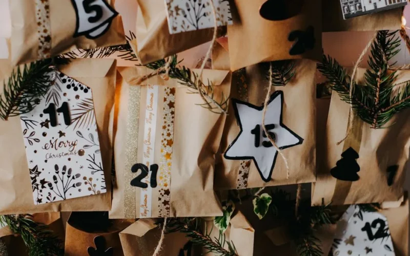 Festive DIY advent calendar with numbered paper bags for Christmas countdown.