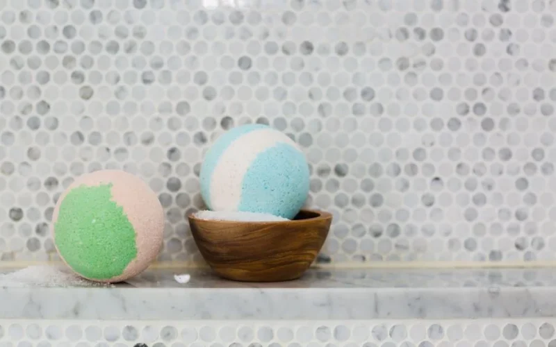 Colorful pastel bath bombs displayed on a marble surface for spa ambiance.