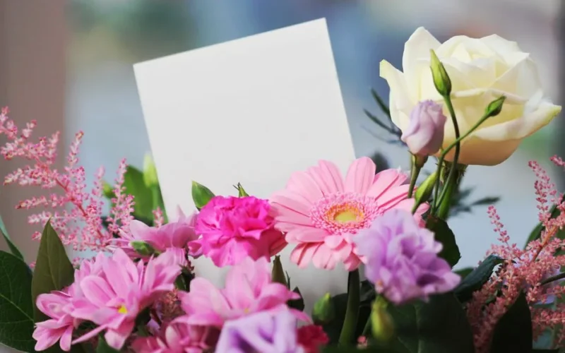 A colorful bouquet of flowers with a blank card, perfect for any occasion.