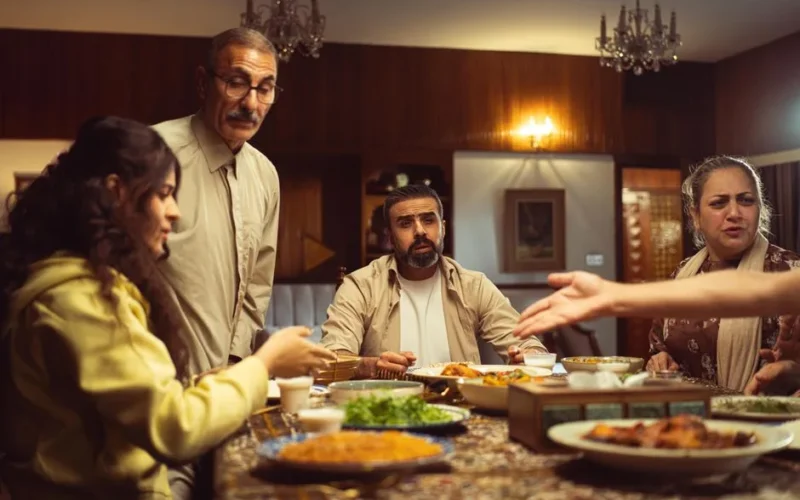 A multi-generational family enjoying a meal together in a warm, inviting indoor setting.