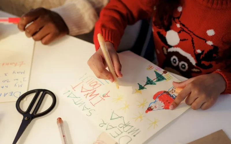 Children crafting heartfelt letters to Santa, full of creativity and holiday cheer.