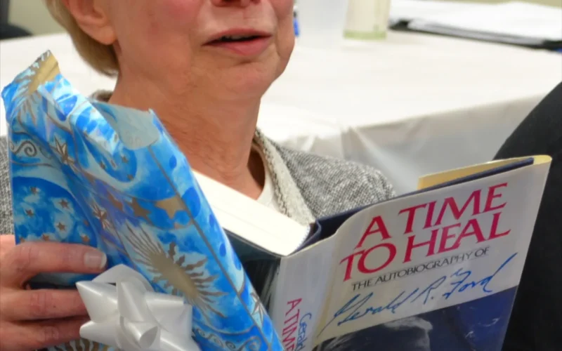 At Helmi Raaska’s retirement party, she received an autograph copy of “A Time To Heal” by Gerald R. Ford.; Location: Geral Ford Presidential Library, Ann Arbor, MI; Photographer: Tina Luckett