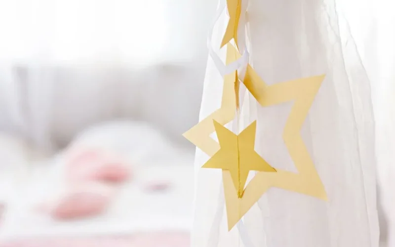 Close-up of paper star decoration with soft blurred background, creating a gentle and serene atmosphere.