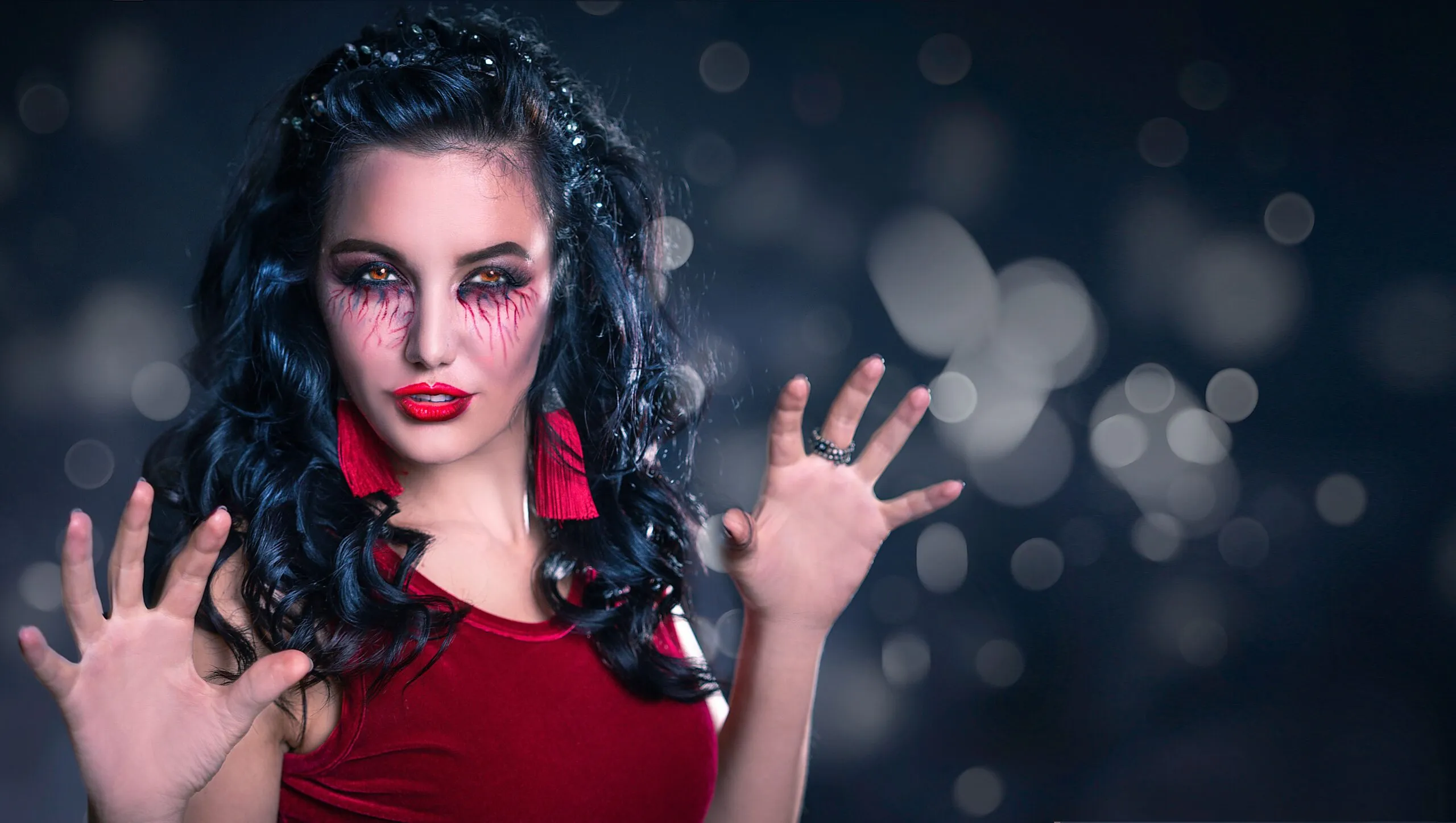 Enchanting woman with creative makeup poses in a mystical setting, perfect for Halloween themes.