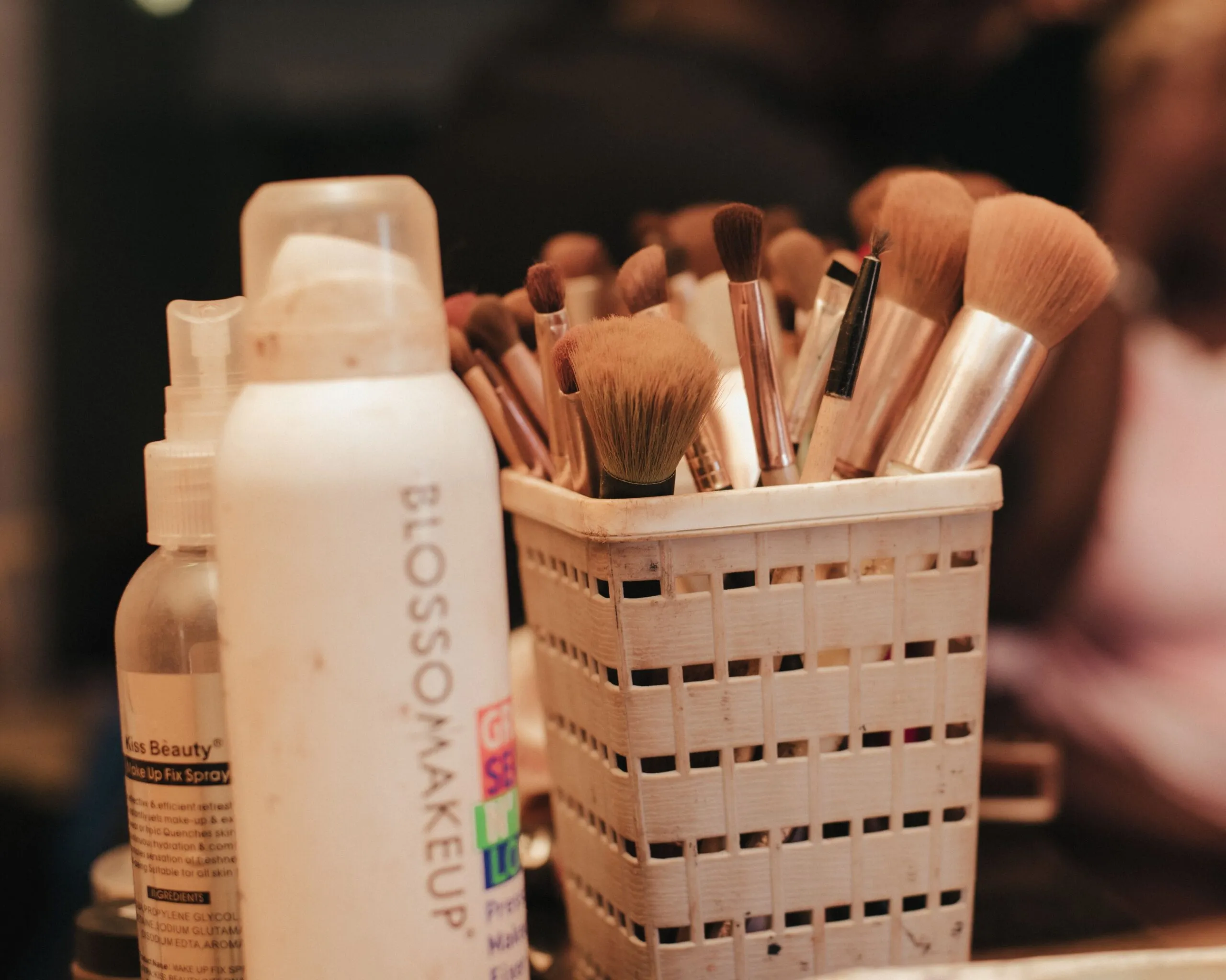 A collection of makeup brushes and beauty products neatly organized in a holder.