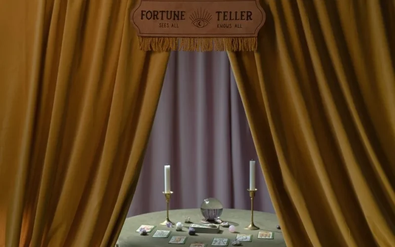 A mystical setup with a crystal ball, candles, tarot cards, and crystals, framed by curtains.