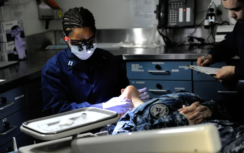 ATLANTIC OCEAN (Jan. 7, 2013) Lt. Nancy N. Okeke, left, examines a dental patient aboard the aircraft carrier USS George H.W. Bush (CVN 77). George H.W. Bush is conducting training and carrier qualifications in the Atlantic Ocean. Dentist office finder (U.S. Navy photo by Mass Communication Specialist 3rd Class Leonard Adams Jr./Released) 130107-N-VA840-032