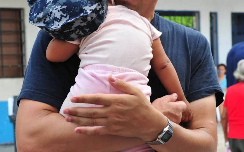 PUERTO SAN JOSE, Guatemala (July 6, 2011) Lt. Cmdr. Jason Layton, a nurse from Wexford, Penn., holds a baby during a Continuing Promise 2011 medical community service project at the Santa Isabel medical site. Continuing Promise is a five-month humanitarian assistance mission to the Caribbean, Central and South America. (U.S. Air Force photo by Staff Sgt. Courtney Richardson/Released)