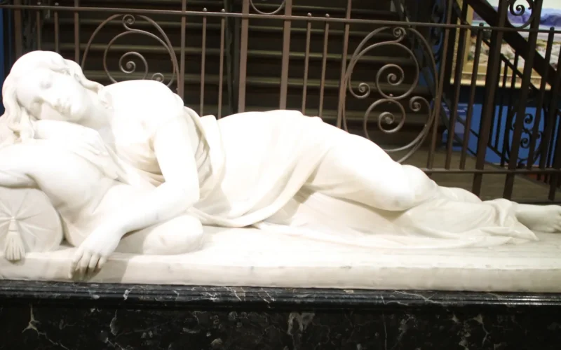 A Sleeping Girl by Edward Hodges Baily, marble statue of a reclining figure in loose sleeping robes, dated 1850, located in the Bristol Museum and Art Gallery