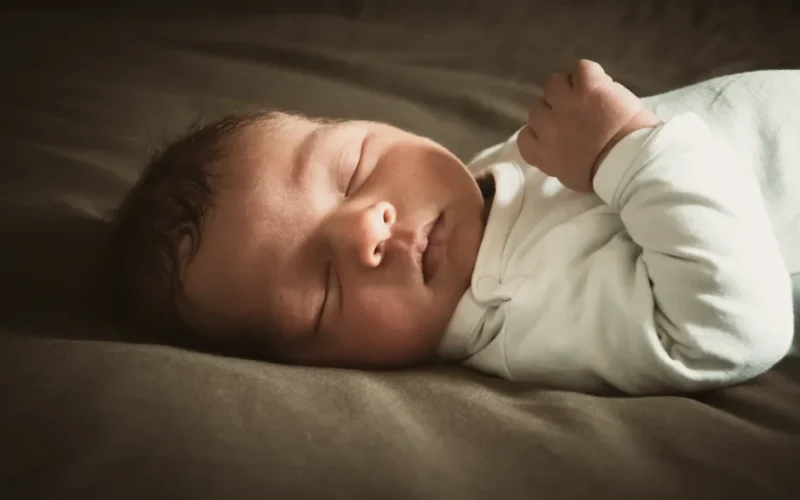 Close-up of a newborn sleeping peacefully indoors with soft lighting. Ideal for lifestyle and family themes.