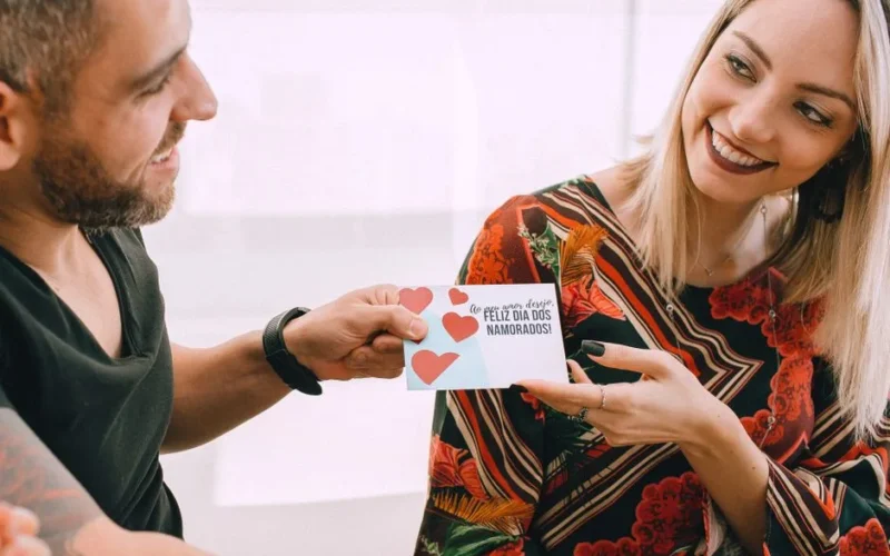 Smiling couple exchanging a heartfelt card on Valentine's Day.