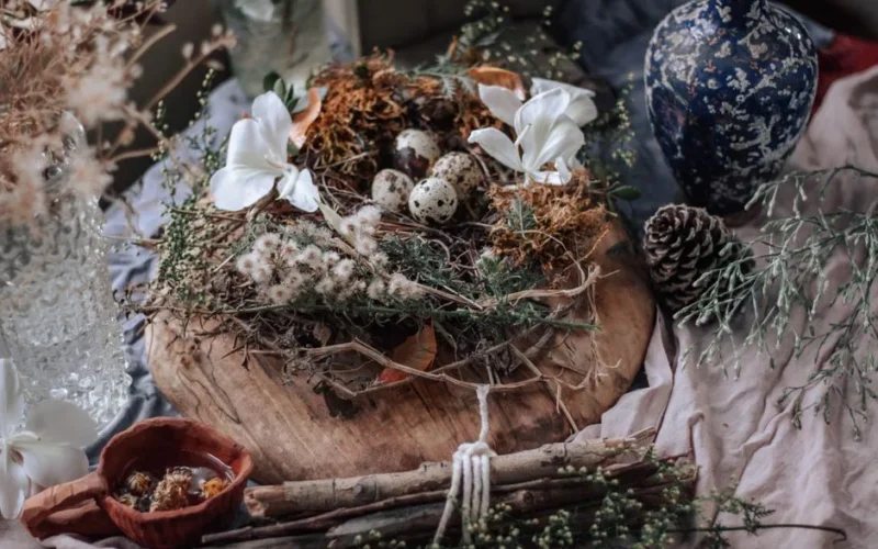 A rustic arrangement featuring a botanical wreath with quail eggs, perfect for spring decor.
