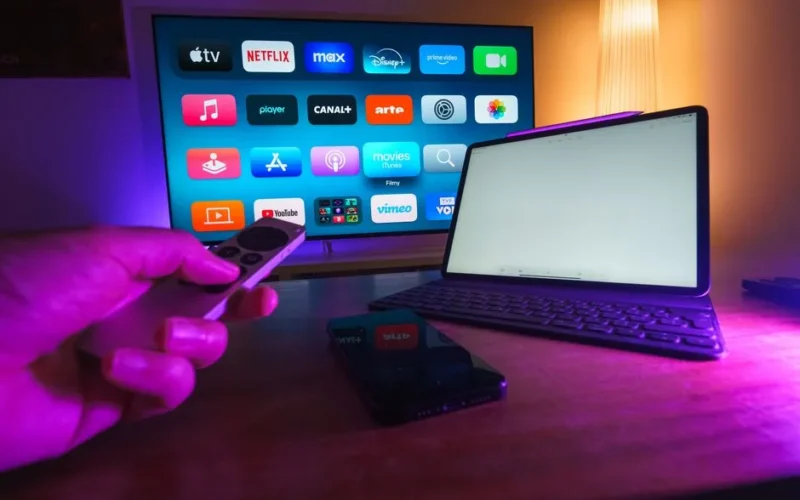 A cozy home setup featuring streaming services on smart TV, tablet, and smartphone.