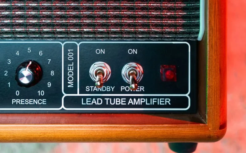 Detailed view of a vintage lead tube amplifier with control switches.