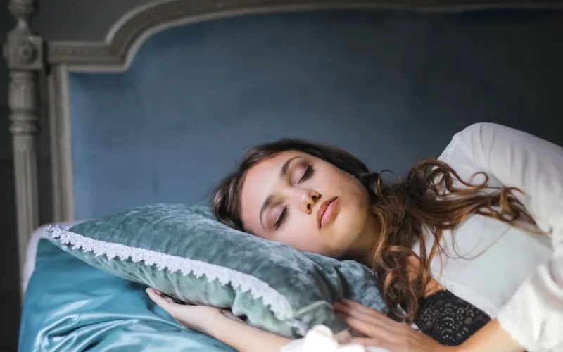 A peaceful woman asleep in a bedroom setting, showcasing relaxation and tranquility.