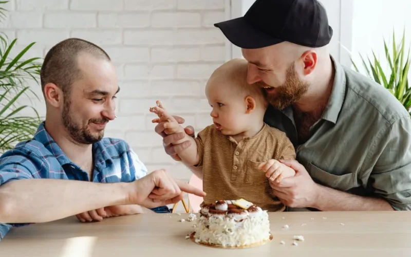 A happy family celebrating a child's birthday with cake indoors, capturing joyful expressions and quality time.