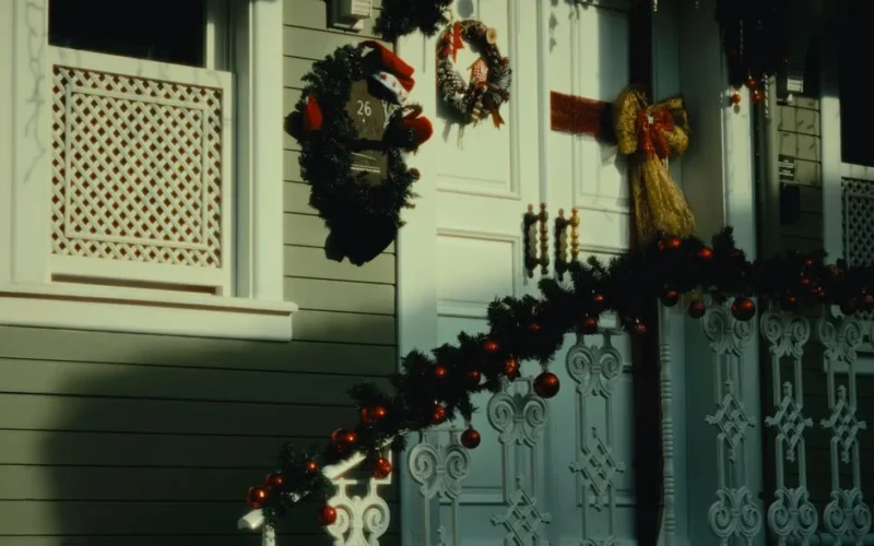 Elegant house adorned with festive Christmas wreaths and garlands, showcasing holiday spirit.