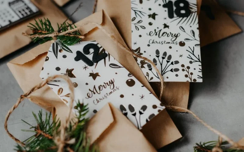 An elegant DIY Christmas advent calendar featuring paper bags and festive decorations.