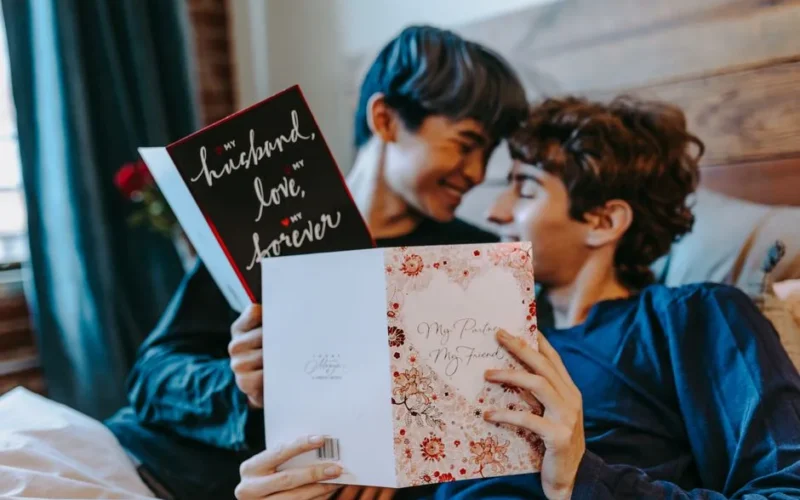 A loving couple enjoying romantic cards together in a cozy indoor setting.
