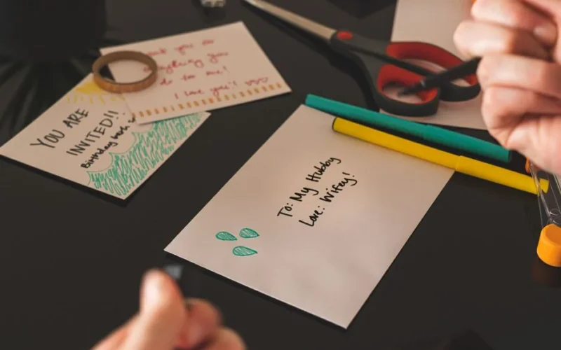 Artistic setup with homemade cards, envelops, and vibrant stationery for crafting.