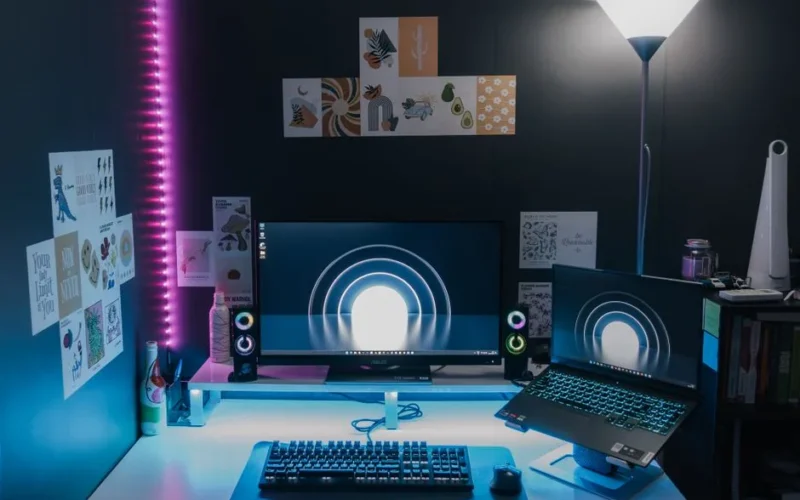 Stylish gaming setup featuring dual monitors, LED lighting, and tech accessories for an immersive experience.