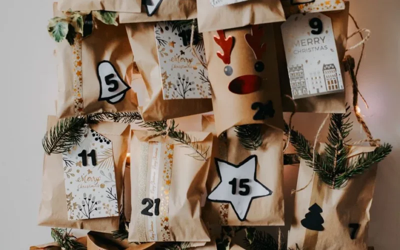 Creative DIY Christmas advent calendar with paper bags and holiday decorations.