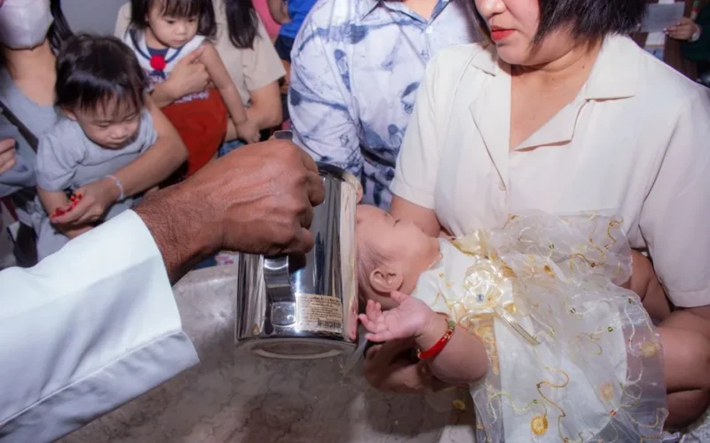 A heartfelt baptism ceremony capturing a baby's christening moment with family.