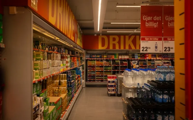 Colorful drink aisle in a supermarket with signage promoting deals.
