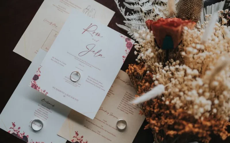 Beautifully designed wedding invitations paired with a rustic bouquet for a natural touch.