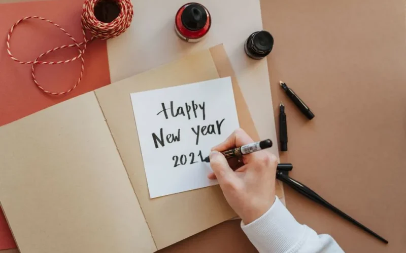 Creating a handmade Happy New Year 2024 card with ink and calligraphy.