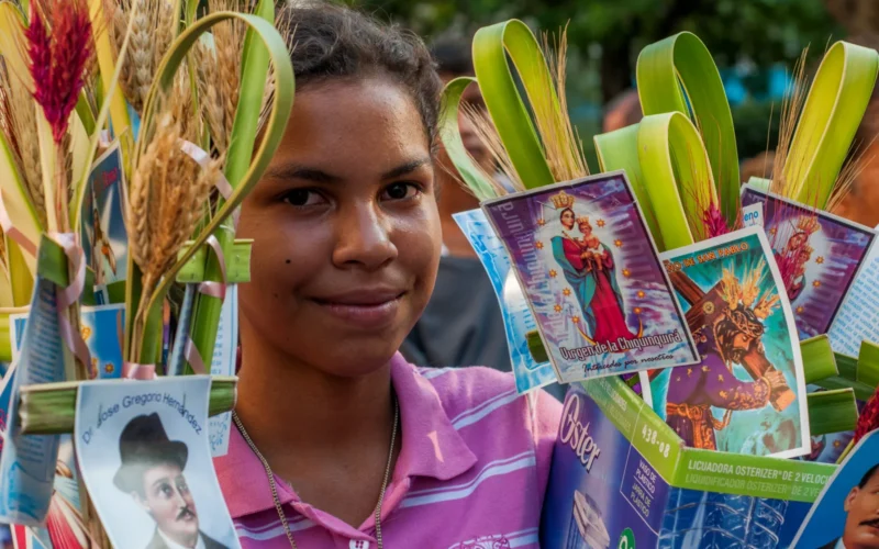 Girl selling palm leaves for Palm Sunday, Maracaibo, Venezuela