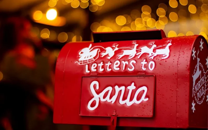 A Christmas-themed red mailbox labeled 'Letters to Santa' with bokeh lights in the background.