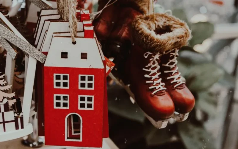 A cozy display of handmade Christmas house and skate ornaments, perfect for winter.