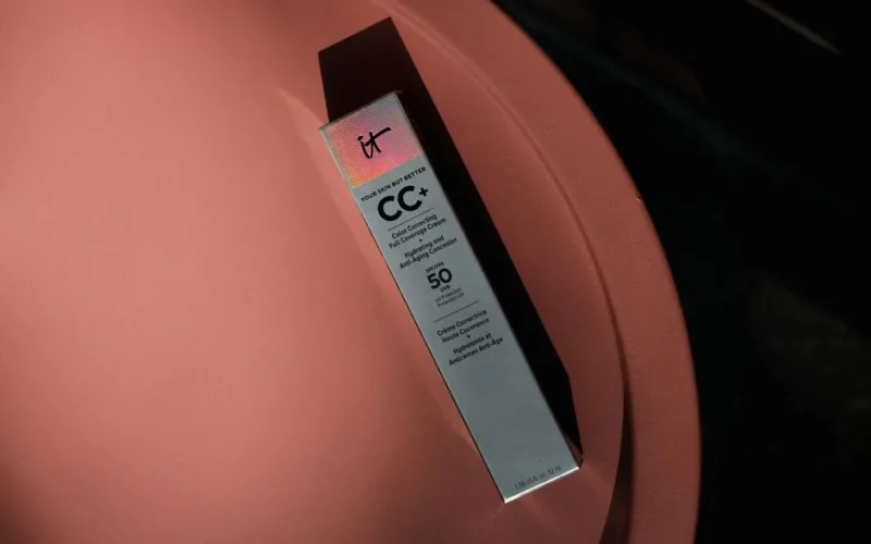 Elegant packaging of a CC+ cream with SPF 50 on a modern, colored table.
