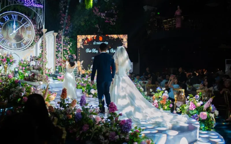 Beautiful wedding ceremony indoors with floral decor and couple in focus.